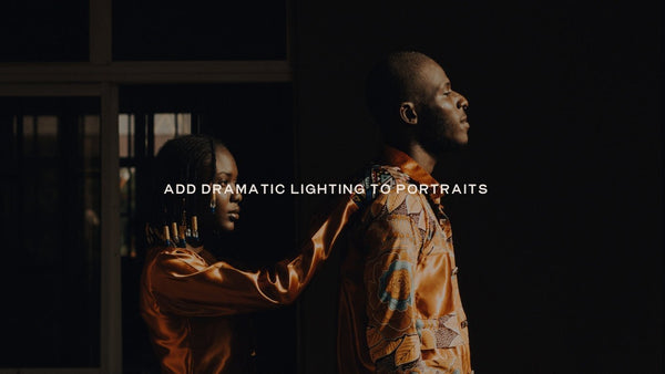 Two people in gold clothing lit from the side against a dark interior