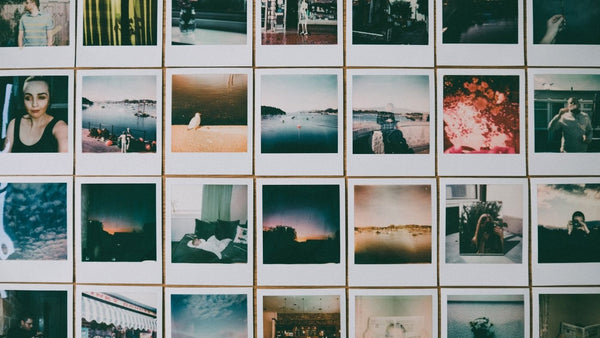 Rows of instant photographs with white borders showing portraits, coastal views, street scenes and everyday moments.