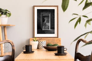 Loose timber and debris lie beyond an empty doorway in Portland, Maine