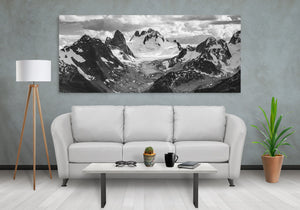 Ridges of glacial ice extend into a high basin surrounded by dark exposed stone.