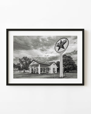 A tall Texaco sign stands beside Ambler’s station in Dwight, Illinois, in a black and white Route 66 photograph.