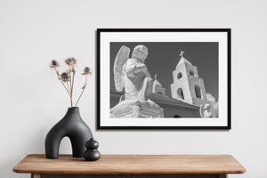Sunlight on pale statues and cross-topped towers of a Bahamas church.