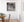 Projecting dormers interrupt the roof slope above orderly rows of narrow window panes.