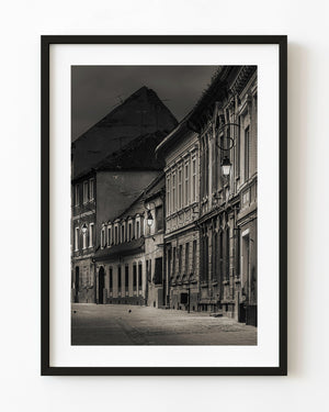 Weathered Brasov houses at dawn along a quiet Romanian street