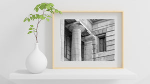 Fluted stone columns and a divided window on a Buenos Aires building.
