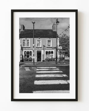 Black and white photograph of Bushmills Post Office and a pedestrian crossing.