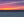 Layers of purple, pink and orange evening light meet blue Pacific water.