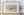 A quiet lake photograph with sparse grasses, gentle reflections and drifting mist.