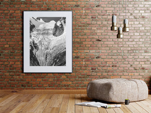 Rugged rock and crevassed glacier textures form a detailed black and white alpine view.