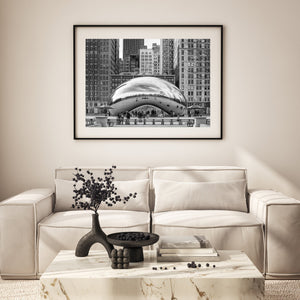 Black and white view of Chicago’s Bean with people gathered beneath its reflective arch.