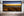 Panoramic Clovelly Beach landscape showing rock pools, open sea and a bright strip of golden dawn.