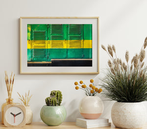 Green and yellow painted train panels show scratches and worn metal surfaces.