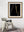 Fine golden lines outline a bottle and flute within deep black negative space.