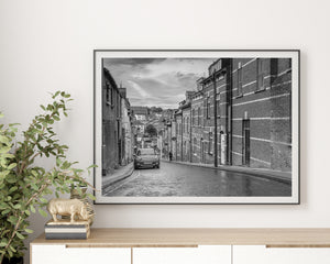 Black and white photograph of Derry architecture beneath a cloudy sky.