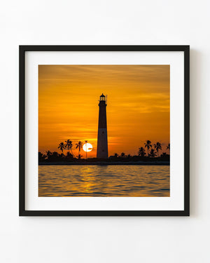 Dry Tortugas lighthouse silhouetted against an orange sunset