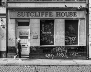 Dublin street photograph of a woman walking past the Sutcliffe House frontage