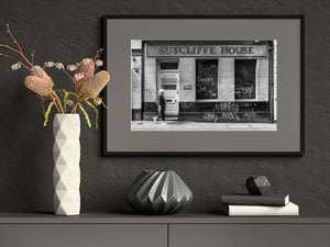 Sutcliffe House lettering above a Dublin street scene in monochrome