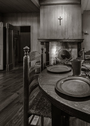 Wooden table and fireplace in a historic Netherlands kitchen