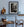 Pewter plates on a rustic table beside a Dutch kitchen hearth