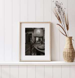 Traditional kitchen interior with a fireplace and wooden chairs