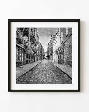 An empty cobblestone street in Dublin’s Temple Bar district at dawn, photographed in black and white.