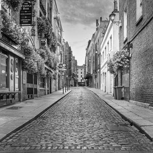 Black and white photograph of a quiet Temple Bar street lined with old buildings.