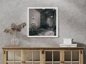 Peeling walls and an iron cell gate show the aged interior of an Illinois jail