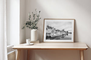Quiet water reflects white tour boats and ornate waterfront buildings in Gdańsk