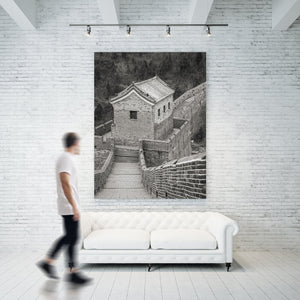 Weathered brickwork and roof ornaments contrast with a wooded Chinese hillside