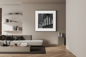 A square monochrome photograph studies Gothic window tracery and stonework in Haarlem