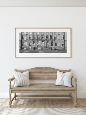 Wiederholte Steinblöcke und Fensterbögen bilden eine detaillierte monochrome Fassade