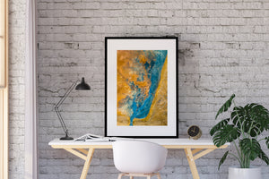 Blaue Mineralformationen zeichnen auf einem isländischen Luftbild einen gekrümmten Kanal durch ockerfarbene Erde nach.