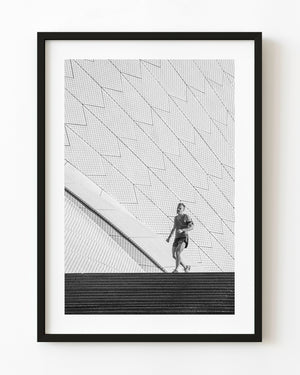 Jogger beside Sydney Opera House’s geometric tiles in black and white