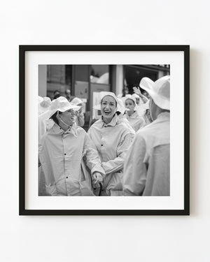 Black and white photograph of women laughing at a Tuscan wine festival