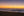 Golden dawn sky above rolling surf and a sandy Long Reef Beach shoreline