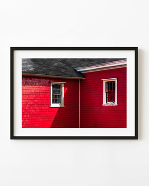 Zwei Fenster mit weißen Einfassungen an einem rot geschindelten Haus in Lunenburg