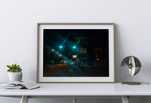Medfield night scene with glowing traffic lights and a corner pizza shop