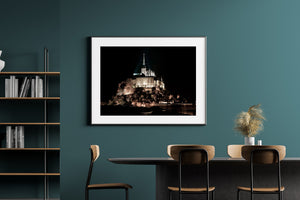 Night architectural photograph of the illuminated abbey and village ramparts