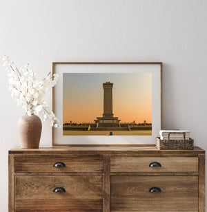 Colour architectural photograph of a stone memorial in warm evening light