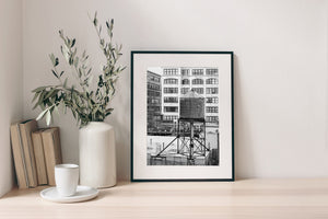Urban landscape featuring a traditional NYC water tower