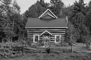 Rustikales Blockbauernhaus mit Spaltholzzaun im ländlichen Ontario, in Schwarzweiß