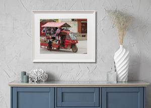 Canopied street vendor truck crowded with hanging merchandise