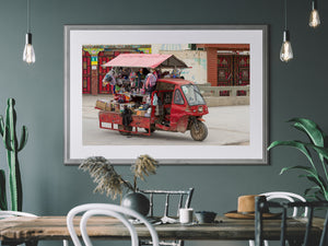 Small red mobile market stall outside a decorated Chinese building