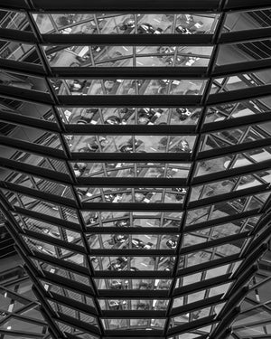 Camera del Reichstag vista attraverso pannelli di vetro ripetuti e travi in acciaio scuro