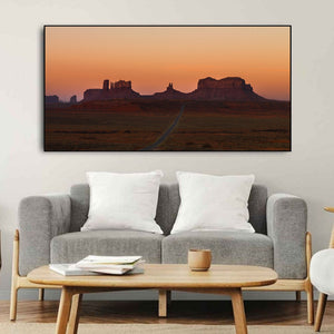 Warm dawn light over Monument Valley’s mesas and spires