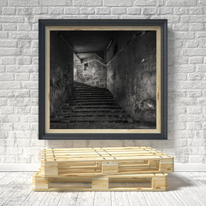 Light falling across the upper landing of a dark Romanian stairwell