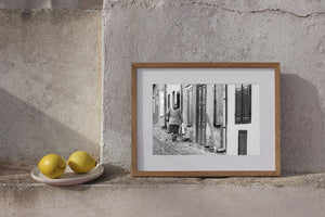 Woman in a headscarf walking away beside peeling plaster walls