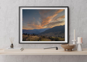 Colour landscape of hillside pastures and evergreen forests in Romania