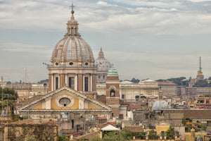 Colour photograph of Rome with a large ribbed dome and warm historic buildings