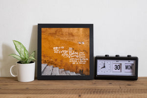 Bold white writing and black tags across a weathered orange wall